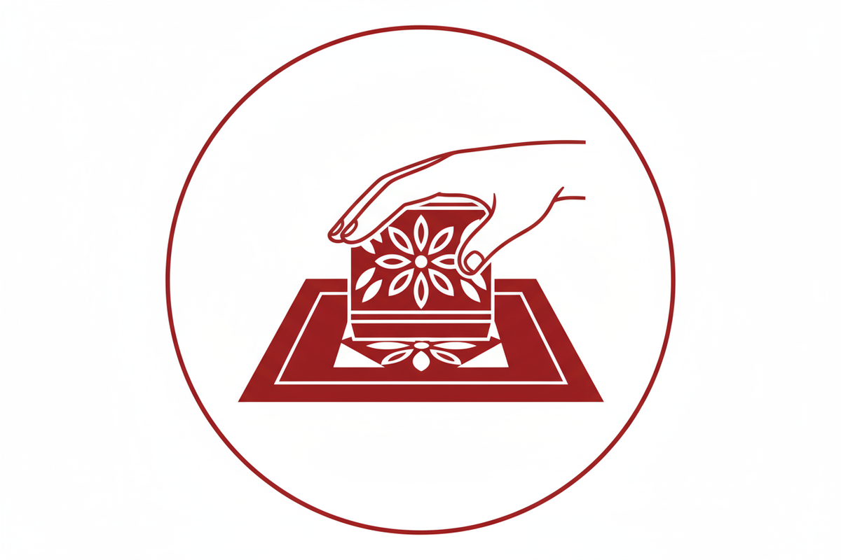 icon showing a hand doing handblock printing on textile, white background, icon in the color #b62928